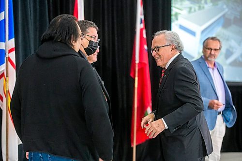 MIKAELA MACKENZIE / WINNIPEG FREE PRESS

Gary Filmon shakes hands with Indigenous leaders after the announcement of the new Gary Filmon Indigenous Terminal at the Exchange Income Corp. annual meeting in the Calm Air hangar in Winnipeg on Wednesday, May 11, 2022. For Martin Cash story.
Winnipeg Free Press 2022.