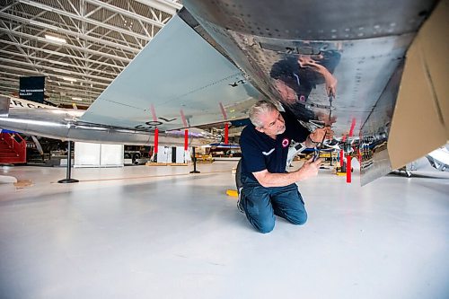 MIKAELA MACKENZIE / WINNIPEG FREE PRESS

Steve Pajot, owner the CF-104 Starfighter, opens up the hydraulics bay of the jet to get the pitot boom out at the new Royal Aviation Museum of Western Canada in Winnipeg on Wednesday, May 11, 2022. For Al Small story.
Winnipeg Free Press 2022.