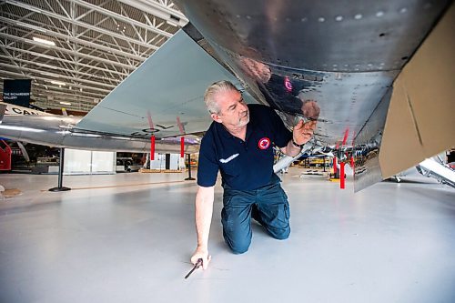 MIKAELA MACKENZIE / WINNIPEG FREE PRESS

Steve Pajot, owner the CF-104 Starfighter, opens up the hydraulics bay of the jet to get the pitot boom out at the new Royal Aviation Museum of Western Canada in Winnipeg on Wednesday, May 11, 2022. For Al Small story.
Winnipeg Free Press 2022.