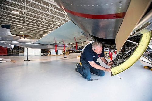 MIKAELA MACKENZIE / WINNIPEG FREE PRESS

Steve Pajot, owner the CF-104 Starfighter, opens up the hydraulics bay of the jet to get the pitot boom out at the new Royal Aviation Museum of Western Canada in Winnipeg on Wednesday, May 11, 2022. For Al Small story.
Winnipeg Free Press 2022.