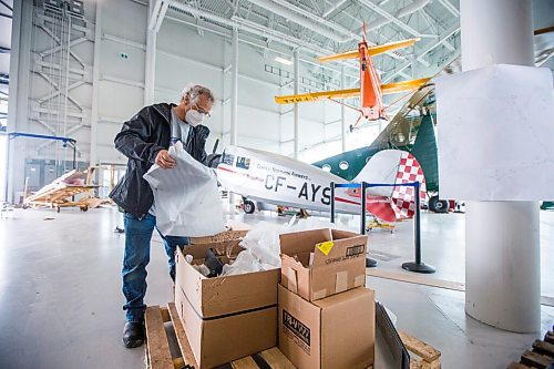 MIKAELA MACKENZIE / WINNIPEG FREE PRESS

Eric Richardson unpacks metal floor guard components at the new Royal Aviation Museum of Western Canada in Winnipeg on Wednesday, May 11, 2022. For Al Small story.
Winnipeg Free Press 2022.