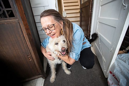 Daniel Crump / Winnipeg Free Press. Karen Kirk hugs her dog, Ziggy, on the porch of her west end home. May 11, 2022.