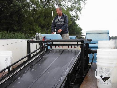 Mike Bellew, who built the algae skimmer, operates it on Killarney Lake. Also, 026 photo is of algae thats been skimmed into a holding tank.  for Bill Redekop story Winnipeg Free Press