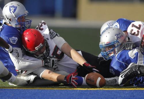 TREVOR HAGAN / WINNIPEG FREE PRESS - Eden Prairie RB ,Chris Erickson, #35, middle, drops the ball on the goal line as they face off against the Oak Park Raiders during the 2010 Can Am Challenge at CanadInns Stadium. 10-09-03