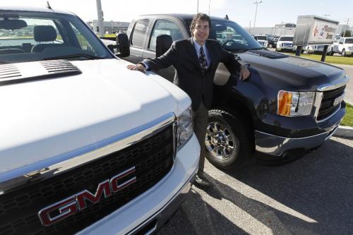 BORIS.MINKEVICH@FREEPRESS.MB.CA  100914 BORIS MINKEVICH / WINNIPEG FREE PRESS Everett Einarson poses with some big trucks at McNaught Pontiak Buick GMC. BIZ job