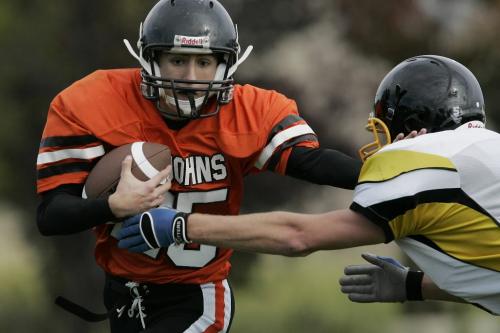 September 17, 2010 - 100917  - St John's Tigers' Kyle Pyrozyk (25) straight arms Fort Francis Muskies' Britton Green (15) to break the tackle in Winnipeg High School footbal action Friday, September 17, 2010.     John Woods / Winnipeg Free Press
