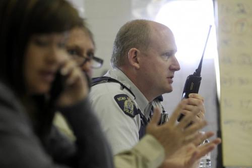 MIKE.DEAL@FREEPRESS.MB.CA 100918 - Saturday, September 18, 2010 -  Emergency officials from over 40 rural municipalities in the Interlake participated in an emergency-preparedness exercise. Oakbank RCMP officer Doug Ashton talks on his radio in the sim room at the fire-station in East St. Paul.  MIKE DEAL / WINNIPEG FREE PRESS