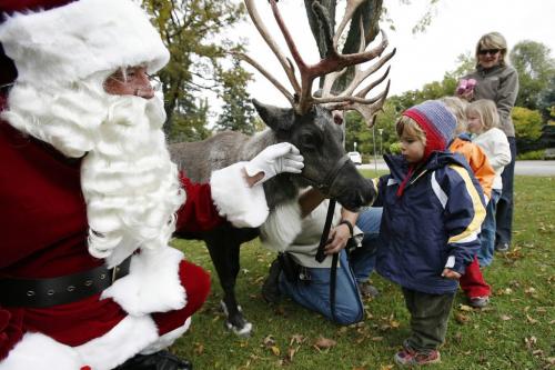 September 23, 2010 - 100923  - September 23, 2010 - 100923  - Santa, Finley Hlannon (2.5) and other children pet a reindeer prior to a press conference to announce the Winnipeg Santa Claus Parade. Santa made a visit to Assiniboine Park today Thursday, September 23, 2010 to announce the upcoming Winnipeg Santa Claus Parade on November 13.    John Woods / Winnipeg Free Press