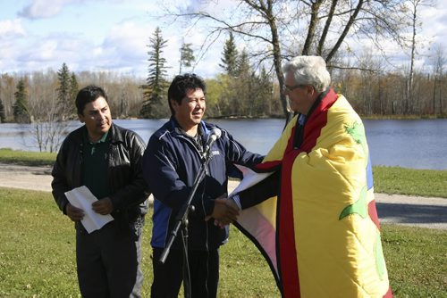 Hollow Water Interpretive Dedication. Shaking the Premier's hand is Marcel Hardisty ¾¢Ç¨Äú Elder who did the pipe ceremony site blessing. On the left is Wesley Moneyas of the Waabanong Anishinaabe Elders Group (referenced in the release as the oversight group) Sept 30 2010.