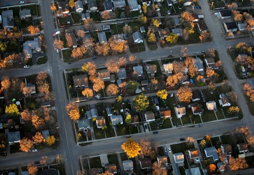 Brandon Sun 07102010 First light illuminates trees reaching out from a residential neighbourhood as seen from a Cessna 172 as the sun rises over Brandon on a clear Thursday morning. (Tim Smith/Brandon Sun)