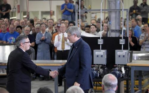 JOE.BRYKSA@FREEPRESS.MB.CALocal-(See Owen story)- Prime Minister Stephen Harper shakes hands with  Tony Clement, Minister of Industry, left, as they use the backdrop of Winnipeg's Bristol Aerospace plant on Berry St to promote his government's controversial purchase of the F-35 fighter jet.- - JOE BRYKSA/WINNIPEG FREE PRESS- Oct 07, 2010