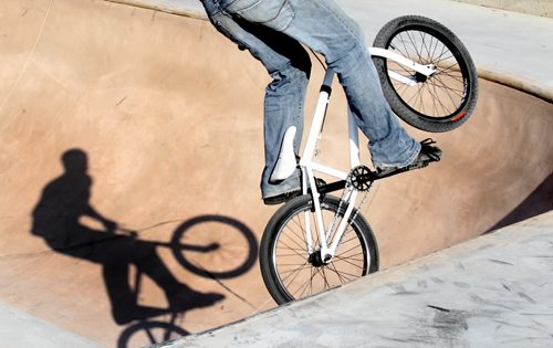 Brandon Sun A BMX cyclist takes to the air while riding in one of the bowls at the Kristopher Campbell Memorial Skateboard Plaza, which is still under construction, on Sunday afternoon. Gates to the site were accidentally left open on Friday and skateboards and cyclist have taken advantage of the newly set surfaces. Painting and a final inspection needs to take place before the plaza is officially opened to the public. (Bruce Bumstead/Brandon Sun)