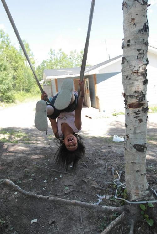 JOE.BRYKSA@FREEPRESS.MB.CA NO RUNNING WATER FEATURE-(See Helen's story)  - Adelaide Rae, 8, from St.Theresa Point First Nation, plays on a swing outside her family home.  - July 2010, - JOE BRYKSA/WINNIPEG FREE PRESS