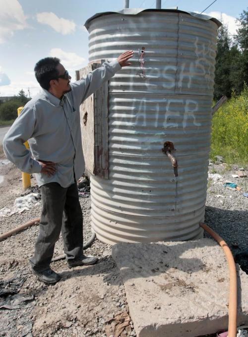 JOE.BRYKSA@FREEPRESS.MB.CA NO RUNNING WATER FEATURE-(See Helen's story)  -  Water plant operator Bruce McDougall at water delivery pipe on Garden Hill First Nation. He says only a few still remain working- July 2010, - JOE BRYKSA/WINNIPEG FREE PRESS