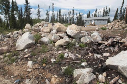 JOE.BRYKSA@FREEPRESS.MB.CA NO RUNNING WATER FEATURE-(See Helen's story)  -   New homes just built at  at Red Sucker Lake First Nation  are quite a job as huge piles of rocks must be cleared to make way for the new homes- July , 2010, - JOE BRYKSA/WINNIPEG FREE PRESS