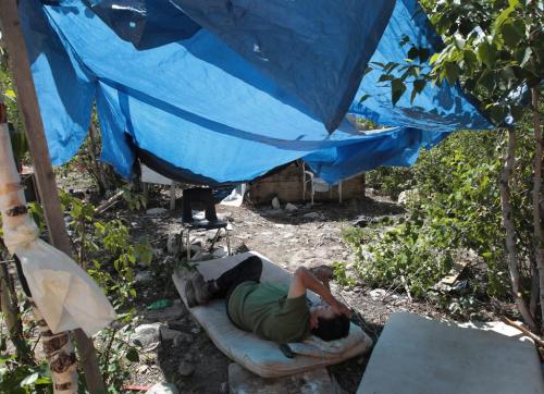 JOE.BRYKSA@FREEPRESS.MB.CA NO RUNNING WATER FEATURE-(See Helen's story)  - Bernard Flett  from St.Theresa Point First Nation lies under a tarp to get out of the hot sun. For years, he and his family have lived with no running wate. He waits as crews renovate his home, including plumbing. The renovation was completed in early September  - July 2010, - JOE BRYKSA/WINNIPEG FREE PRESS