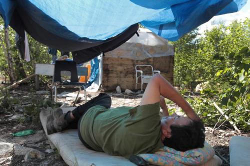 JOE.BRYKSA@FREEPRESS.MB.CA NO RUNNING WATER FEATURE-(See Helen's story)  - Bernard Flett from St.Theresa Point First Nation lies under a tarp to get out of the hot sun. For years, he and his family have lived with no running water. He waits in the summer as  crews renovate his home, including plumbing, which was finally complete in early September - July 2010, - JOE BRYKSA/WINNIPEG FREE PRESS