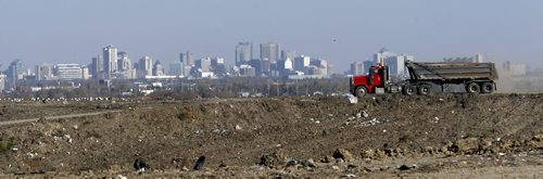 KEN GIGLIOTTI / WINNIPEG FREE PRESS  / Oct  15 2010 - 101015 - Lindsey Wiebe story  Brady Road  Landfill site feature - with Winnipeg in the background   dump trucks bring clay to cover the garbage  forming what will be a grassy hillside