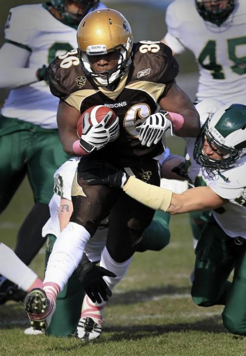 MIKE.DEAL@FREEPRESS.MB.CA 101016 - Saturday, October 16, 2010 -  University of Manitoba Bisons football team plays against the University of Regina Rams at the University Stadium on Saturday. Bisons' Matt Henry (36) is pulled down by Rams' Matt Yausie (10), right, and Bruce Anderson (40), behind, in the first half. MIKE DEAL / WINNIPEG FREE PRESS