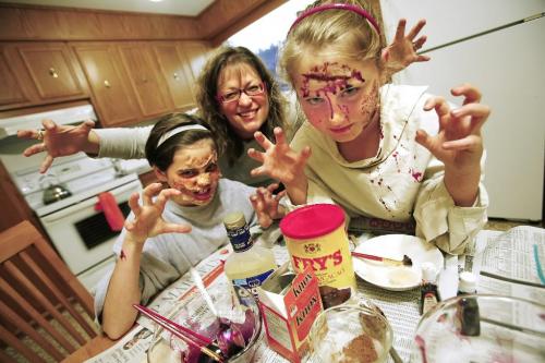 Angela Fey, a woman who is an expert at doing gory makeup from ordinary kitchen ingredients, applied makeup on Emily Dahl (9) (R) and her friend Emily Slater (10) in Fey's kitchen on Friday, October 15, 2010.    Winnipeg Free Press/John Woods