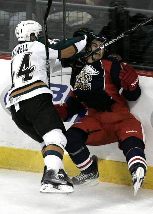 Manitoba Moose Tommy Maxwell (44) takes out Grand Rapids Griffens Brendan Smith (7) behind Smith's goal during the second period of their AHL game in Winnipeg Saturday, October 16, 2010.    Winnipeg Free Press/John Woods