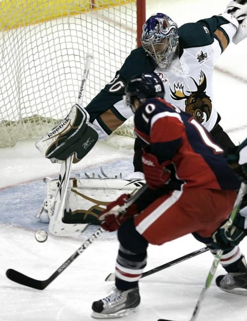 Manitoba Moose goalie Tyler Weiman (30) robs Grand Rapids Griffens Jamie Johnson (10) of the goal during the second period of their AHL game in Winnipeg Saturday, October 16, 2010.    Winnipeg Free Press/John Woods