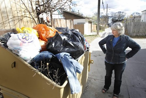 WAYNE.GLOWACKI@FREEPRESS.MB.CA  North End resident Rae Butcher, who writes a blog called A Day In The Hood stands by an overflowing dumpster in the backlane near her home. Today is one day before garbage pickup. Gord Sinclair story.  Winnipeg Free Press Oct 20 2010
