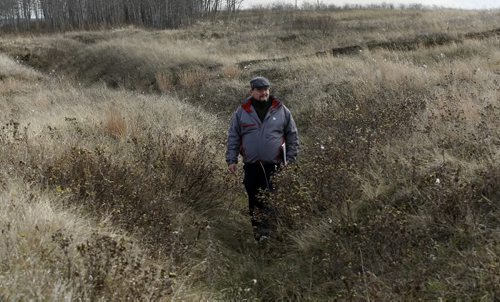 KEN GIGLIOTTI / WINNIPEG FREE PRESS  / Oct  20 2019 - 101020 - Kevin Rollason  Remembrance Day features  story -  in pic  military historian Bruce Tascona  walks through   trench system  at  former WW1 trench warfare training area at Camp Hughes  ( formerly Camp Sewell ) , near Carberry . Camp Sewell  was opened  in 1909 and the name was changed to Camp Hughes in 1915 -  Camp Hughes was named after Major-General Sir Sam Hughes , 38,000 troops of the Canadian Expeditionary Force  trained in trench warfare , many fought Vimy Ridge