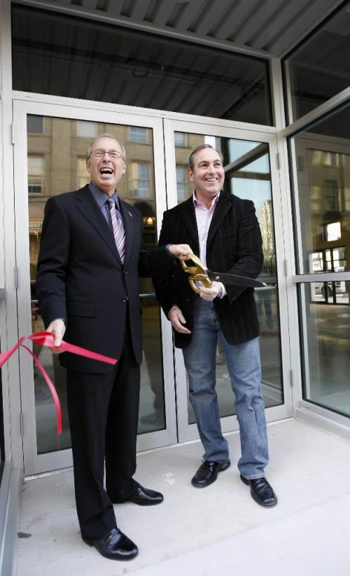 KEN GIGLIOTTI / WINNIPEG FREE PRESS  / Oct  21 2010 - 101021 - Sam Katz and Ken Reiss VP of Bedford Investments cut the ribbon at the opeing . The 159-stall Bedford Parkade in the Exchange District officially opens Friday at the southwest corner of King Street and Bannatyne Avenue, where the Ryan Block stood from 1895 until 2009.THe new building  is built  to be in character with the Exchange Bldgs using recycle brick   and retro design on the corner section of the structure .