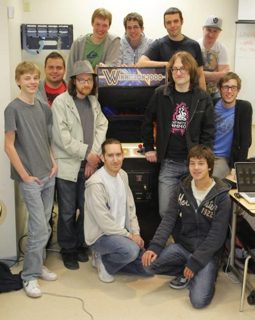 BORIS.MINKEVICH@FREEPRESS.MB.CA  101024 BORIS MINKEVICH / WINNIPEG FREE PRESS The Winnitron and Friends. Winnipeg game programmer Alec Holowka poses for a photo with a group of game programmers with the Winnitron 1000, an old arcade machine that they converted to play new games they made. Alec is in black with pink on his shirt standing next to the machine (right of the machine)