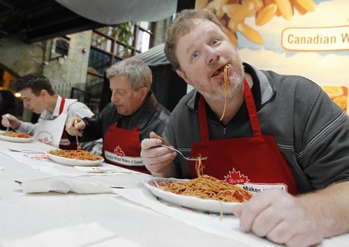 TREVOR HAGAN / WINNIPEG FREE PRESS - From left, Russ Hobson, Jon Ljungberg and Doug Speirs during a spaghetti eating competition at The Forks. 10-10-25