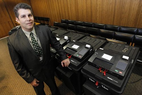 TREVOR HAGAN / WINNIPEG FREE PRESS - Senior Election Official, Marc Lemoine, with voting machines inside City Hall. 10-10-26