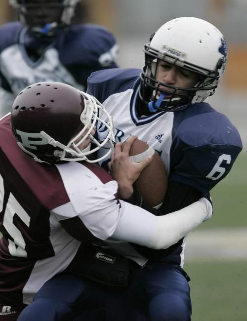 October 29, 2010 - 101029  - Grant Park Pirates Sylvester Alexander (6) is  sacked by St Paul's Crusaders AA Mitchell Armstromg (25) in the quarter finals at Canad Inn Stadium Friday, October 29, 2010.    John Woods / Winnipeg Free Press