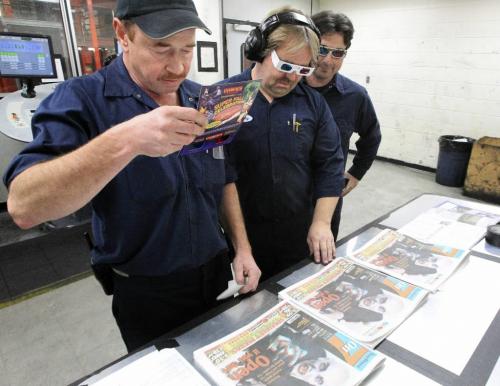 MIKE.DEAL@FREEPRESS.MB.CA 101031 - Sunday, October 31, 2010 -  Pressmen look at the 3D On7 as it rolls off the press on Halloween. Winnipeg's first newspaper to print the majority of it's images in a 3D special edition. MIKE DEAL / WINNIPEG FREE PRESS