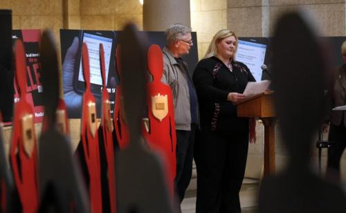 WAYNE.GLOWACKI@FREEPRESS.MB.CA    Beside wooden silhouettes representing murdered women in Manitoba as a result of domestic violence, Pamela Creighton beside her father Edward Creighton speaks about her sister Jennifer Creighton who was murdered in 2002 at The Silent Witness Project vigil held in the Manitoba Legislative Bld. Monday. The vigil followed a gov't announcement as November is Domestic Violence Prevention Month that the province has launched a strategy at preventing domestic violence including an awareness campaign, programing to support at risk families and a new website. Bruce Owen Story  Winnipeg Free Press Nov.1 2010