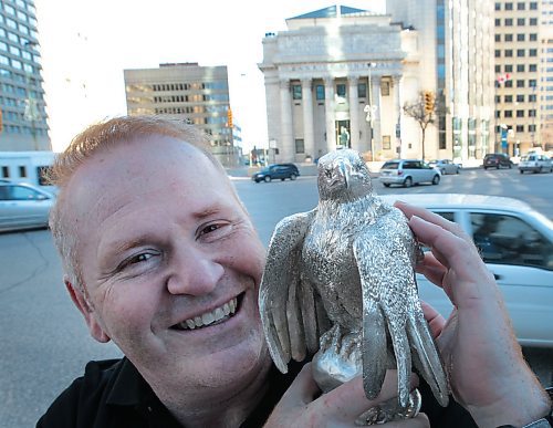 JOE.BRYKSA@FREEPRESS.MB.CA Ent- ( see vessley story)   -  Ron Shore holds a solid silver  eagle statue at Portage and Main St in Winnipeg Wednesday afternoon- Shore wrote the book called The World's Greatest Treasure Hunt. which will see readers search for 12 silver eagles and the grand prize of a golden eagle worth 1.5 million-   A portion of the proceeds of this book will be donated to  breast cancer fundraiser.Shore's family has been effected in many ways by cancer so he wanted to give back to the cause--  JOE BRYKSA/WINNIPEG FREE PRESS- Nov 03, 2010