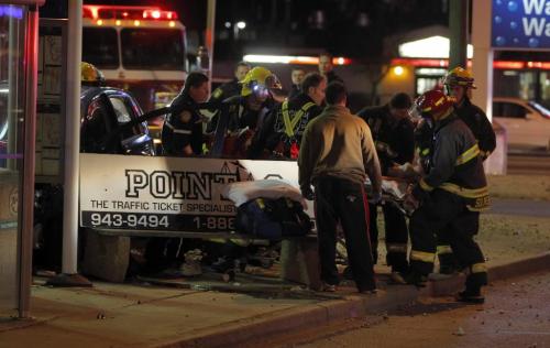 BORIS.MINKEVICH@FREEPRESS.MB.CA   BORIS MINKEVICH / WINNIPEG FREE PRESS 101103 Car crash on McPhillips and Inkster. The woman went to hospital RED. Stolen car unit on scene as well. Ironicly a points traffic ticket bench advertizment.