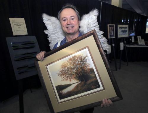 MIKE.DEAL@FREEPRESS.MB.CA 101104 - Thursday, November 04, 2010 -  Pennies from Heaven launch at the Manitoba Art Expo. Kevin Rollason with an original print called River Oak by Hubert Theroux at the Manitoba Art Expo. MIKE DEAL / WINNIPEG FREE PRESS