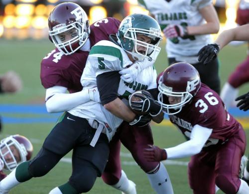 BORIS.MINKEVICH@FREEPRESS.MB.CA   BORIS MINKEVICH / WINNIPEG FREE PRESS 101104 Winnipeg Highschool AAA football playoffs - St. Paul Crusaders vs. Vincent Massy Trojans. Trojan's #5 Steve Robinson tries to slip away from some big Crusader's.