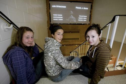 November 4, 2010 - 101104  - On Thursday, November 4, 2010 grade eight students (LtoR) Melanie Bretecher, Kiara Gladish, and Louise Riou at Ecole Lacerte look at a cross-Canada vigil in which the names of WW1 veterans are projected on a wall for 25 seconds each. Today the school projected the project in a hallway for all to see and on November 10 they are planning a school vigil in the gym and planning to project the names during the vigil.    John Woods / Winnipeg Free Press