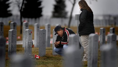 PHIL.HOSSACK@FREEPRESS.MB.CA 101111-Winnipeg Free Press Jessica Robinson and her father Sandy Robinson pay their respects at the grave of Sgt Tommy Prince THursday afternon at Brookside Cemetary.  Prince, origionaly from Brokenhead, was the most decorated aboriginal soldier in the 2nd World War....(I think).....He died in Winnipeg in 1977.