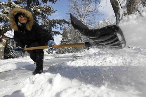 TREVOR HAGAN / WINNIPEG FREE PRESS - Effie Wesley shovels snow in front of her house on Radford Street. 10-11-19