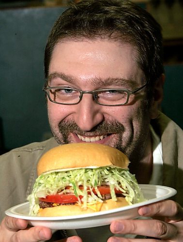 BORIS MINKEVICH / WINNIPEG FREE PRESS  060502 Burger man Angelo De Francesco with a fine burger. He has a blog on Winnipeg hamburgers.