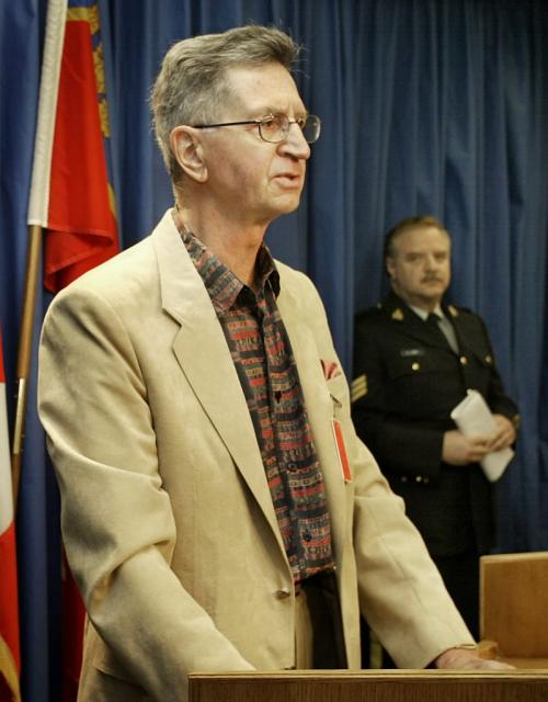 Doctor James Tindle, a former Winnipeg Police Detective takes questions from the media during a briefing in Vancouver April 30, 2002. Tindle was  instrumental in dogging the police to lay charges in the Eron Mortgage scandal. In the background is Staff Sargent Grant Learned.  Lyle Stafford/Winnipeg Free Press
