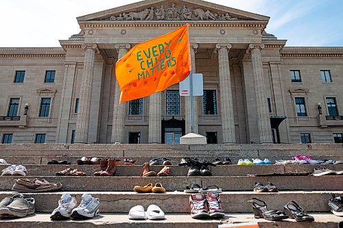 Daniel Crump / Winnipeg Free Press. An orange flag with the words &#x201c;every child matters&#x201d; written on it flies above shoes that have been placed on the steps of the Manitoba legislature. The display is in honour of the children whose bodies have recently been discovered in unmarked graves at the former residential school sites across Canada. July 3, 2021.