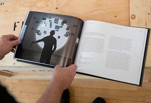 JESSICA LEE / WINNIPEG FREE PRESS

Chris Dorosz shows a book of his exhibition on November 1, 2021 in his studio in downtown Winnipeg. This particular work he is showing uses Winnipeg Free Press newspaper clippings that he pokes holes into.

Reporter: Alan







