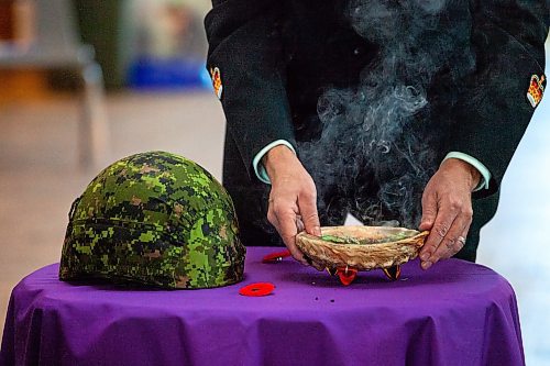 Daniel Crump / Winnipeg Free Press. A soldier tends to the smudge during the Manitoba Indigenous Veterans Inc. virtual commemoration event for National Indigenous Veterans Day at Thunderbird House in Winnipeg. November 8, 2021.