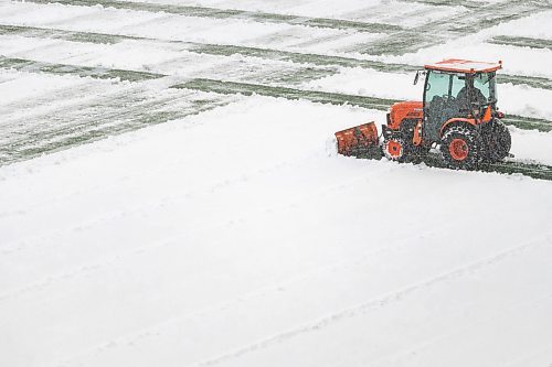 Daniel Crump / Winnipeg Free Press. Machines work to clear snow from the field prior to the Canada West football semifinal between the University of Manitoba Bisons and the University of Alberta Golden Bears at IG Field in Winnipeg on Saturday. November 13, 2021.