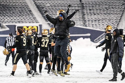 Daniel Crump / Winnipeg Free Press. Bisons players and staff celebrate after defeating the Alberta Golden Bears in the Canada West football semifinal at IG Field in Winnipeg on Saturday. November 13, 2021.