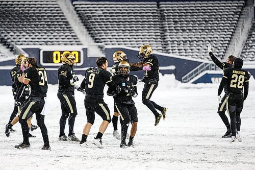 Daniel Crump / Winnipeg Free Press. Bisons players and staff celebrate after defeating the Alberta Golden Bears in the Canada West football semifinal at IG Field in Winnipeg on Saturday. November 13, 2021.